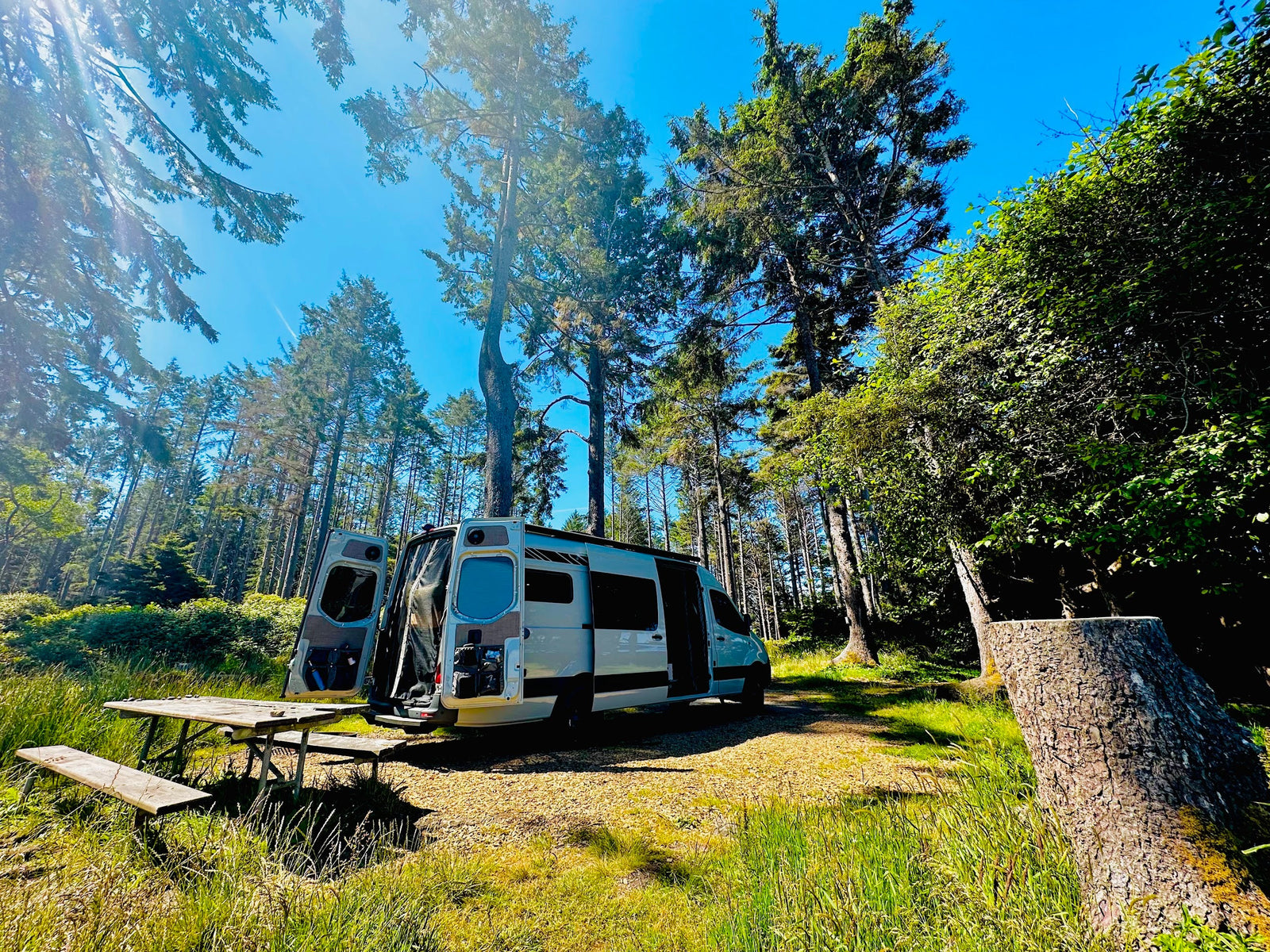 Mike and Allison's RB 4x4 Sprinter adventure van at a forest campsite